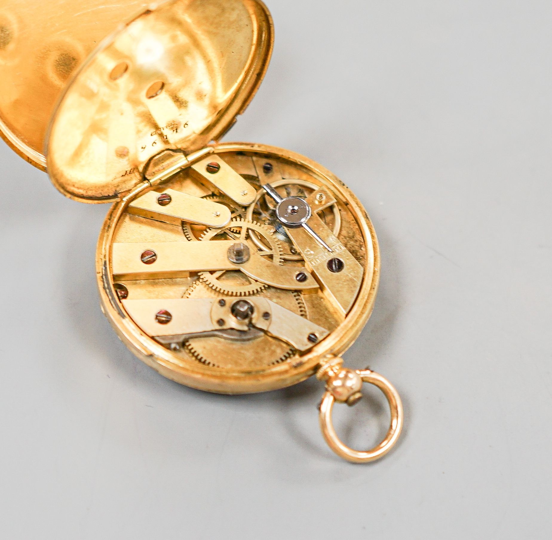 A continental yellow metal, enamel and diamond chip set open face fob watch, decorated en verso with the bust of a lady